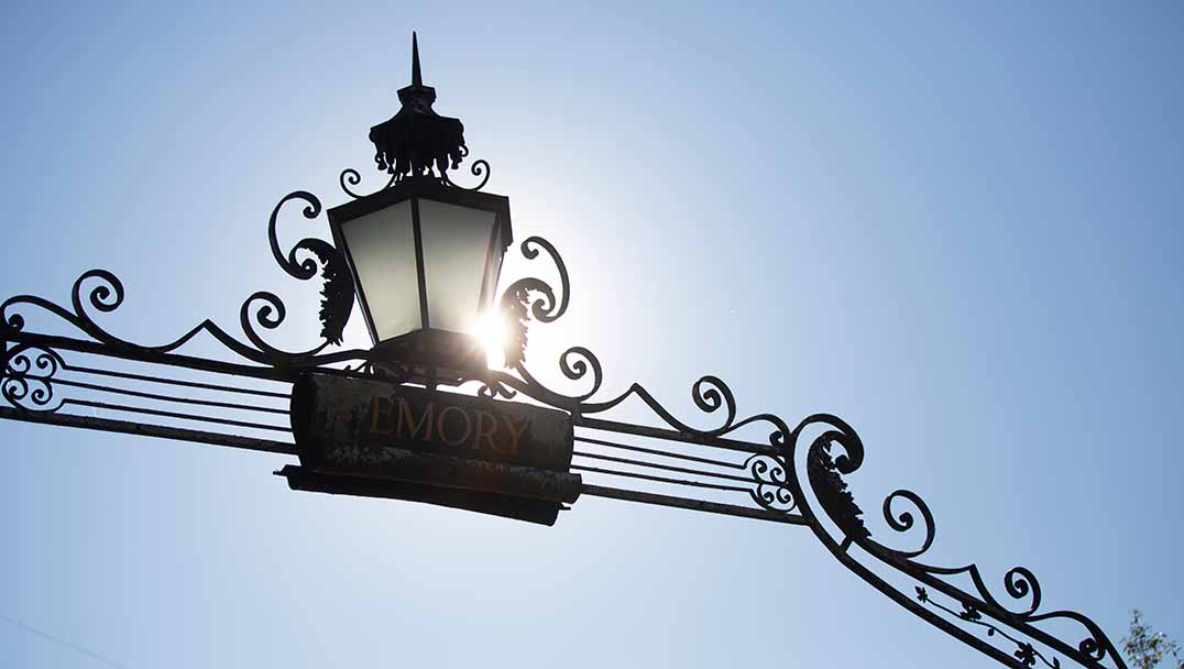 top of entrance gate with sun flare and blue sky